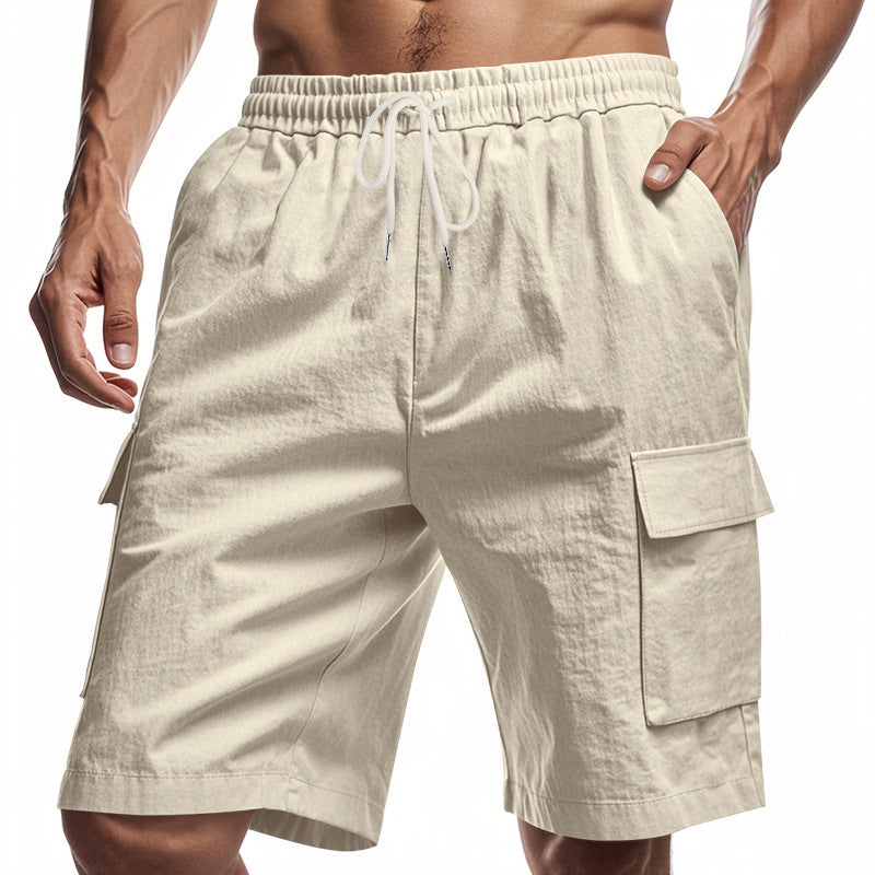 Men’s solid color linen shorts with elastic waist and cargo pockets.