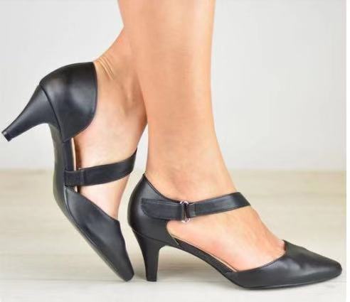 Pointed toe cross strap sandals with short stiletto heel in black.