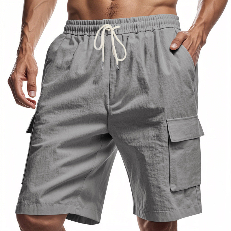 Men's grey linen shorts with elastic waist and pockets.