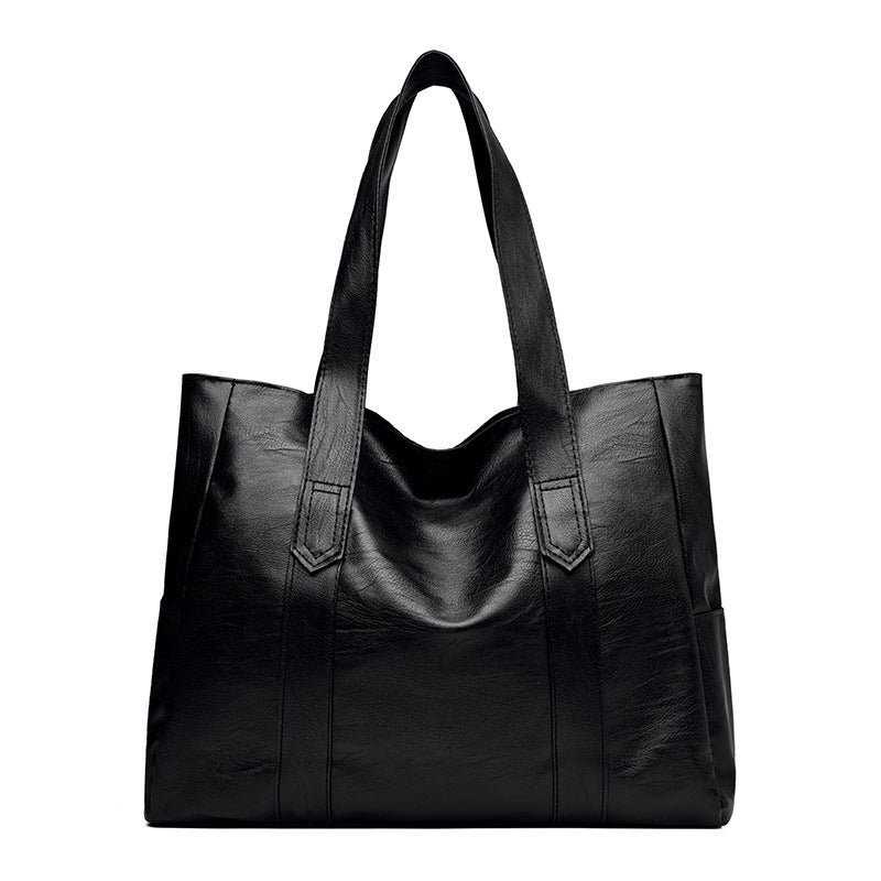 Versatile large capacity tote bag in black PU leather.