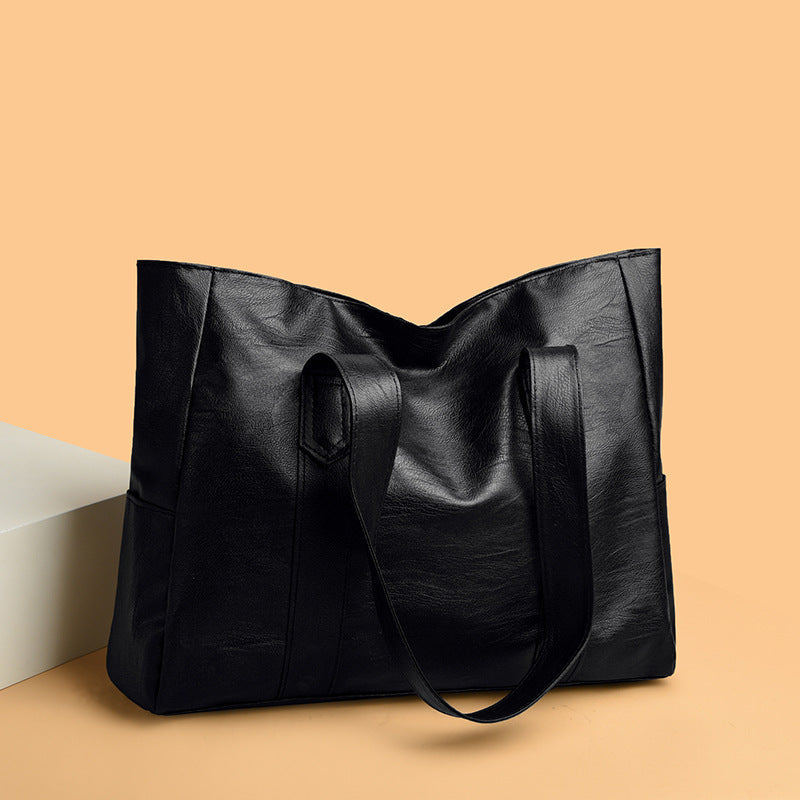 Large capacity black PU leather tote bag with spacious compartments.