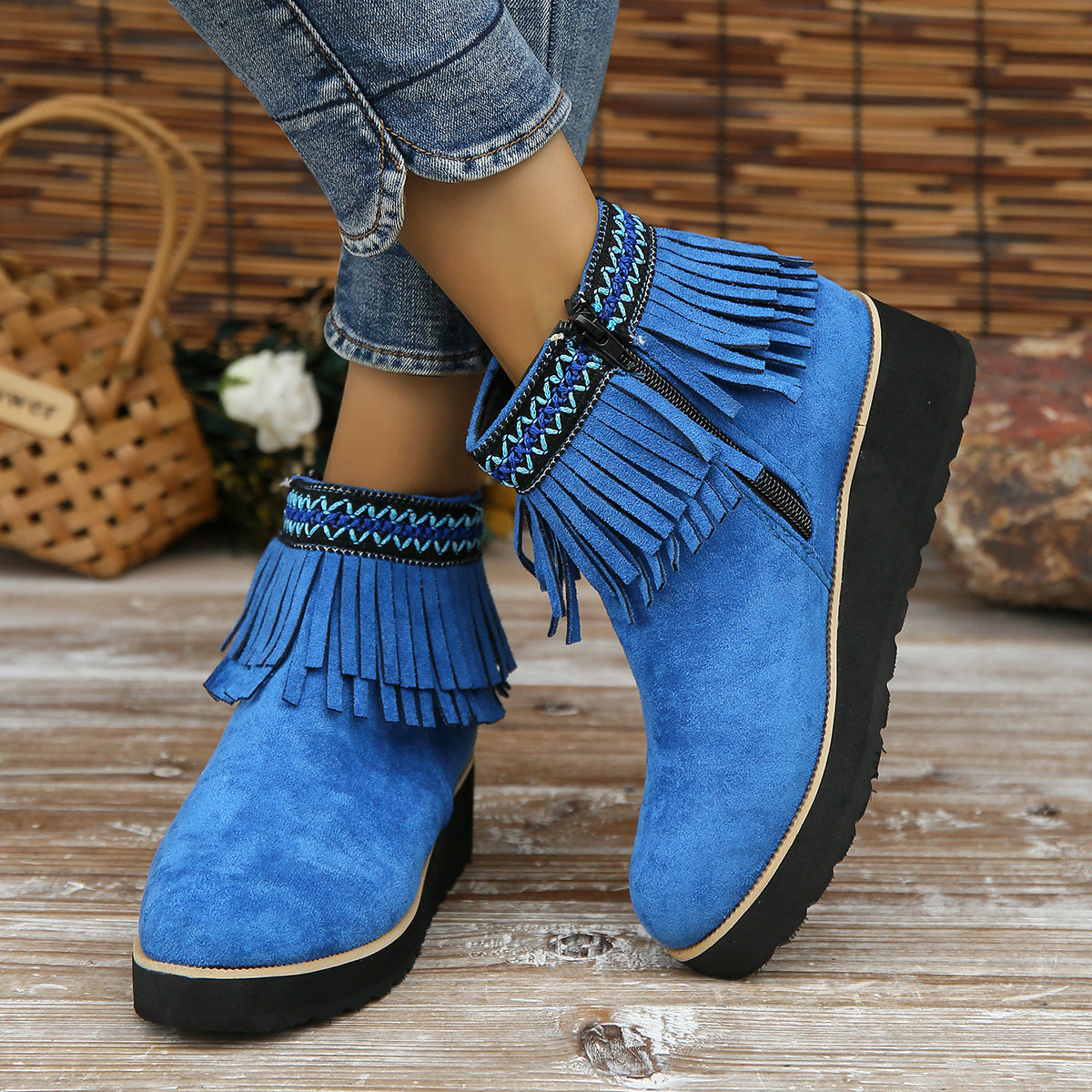 Women's blue suede ankle boots with fringe, wedge heel, and side zipper.