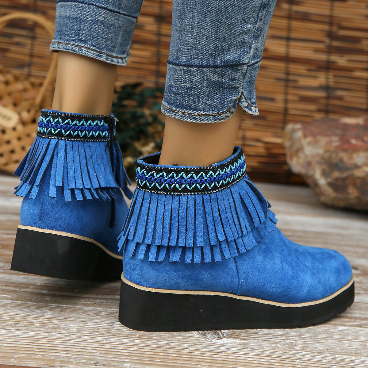 Fashion blue suede ankle boots with fringe and wedge heel.