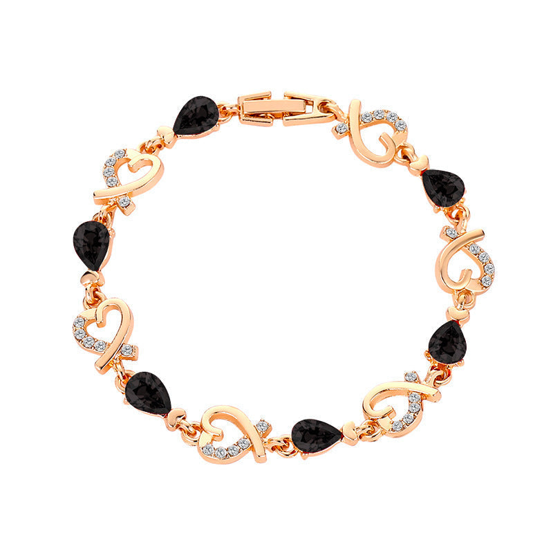 Heart-shaped bracelet with rhinestones and copper finish.