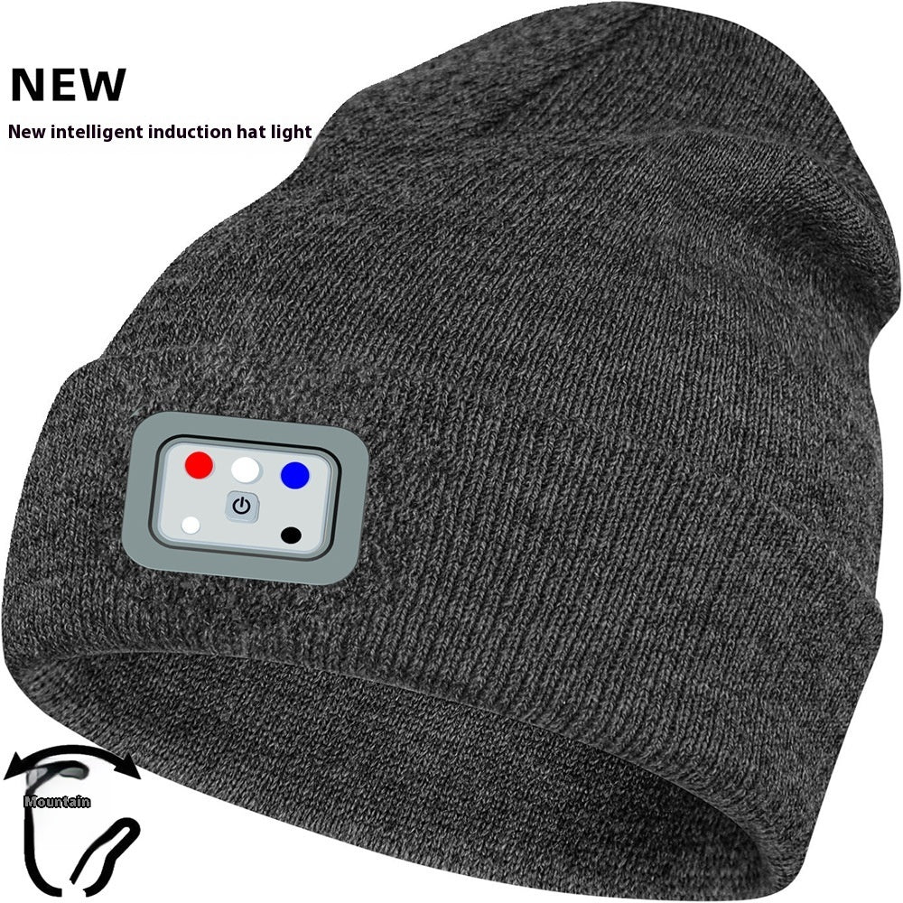 Gray knit toque with built-in light, ideal for winter outdoor activities.