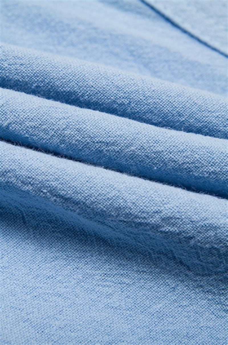 Close-up of light blue cotton-linen fabric used in men's Bermuda shorts.