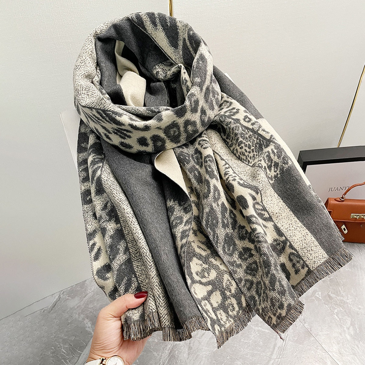 Leopard print shawl in imitation cashmere fabric with color-blocking design.