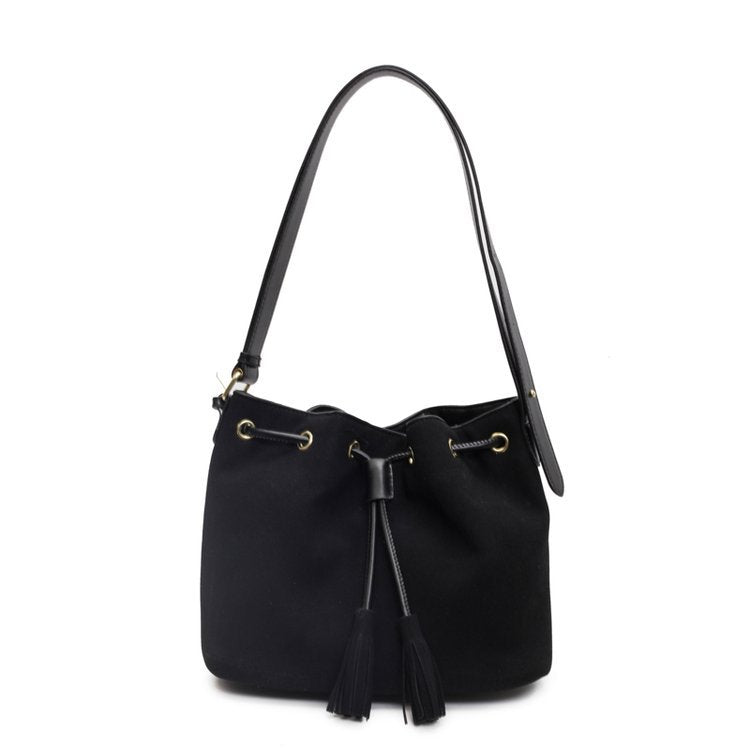 Stylish black bucket bag with tassel and single shoulder strap.