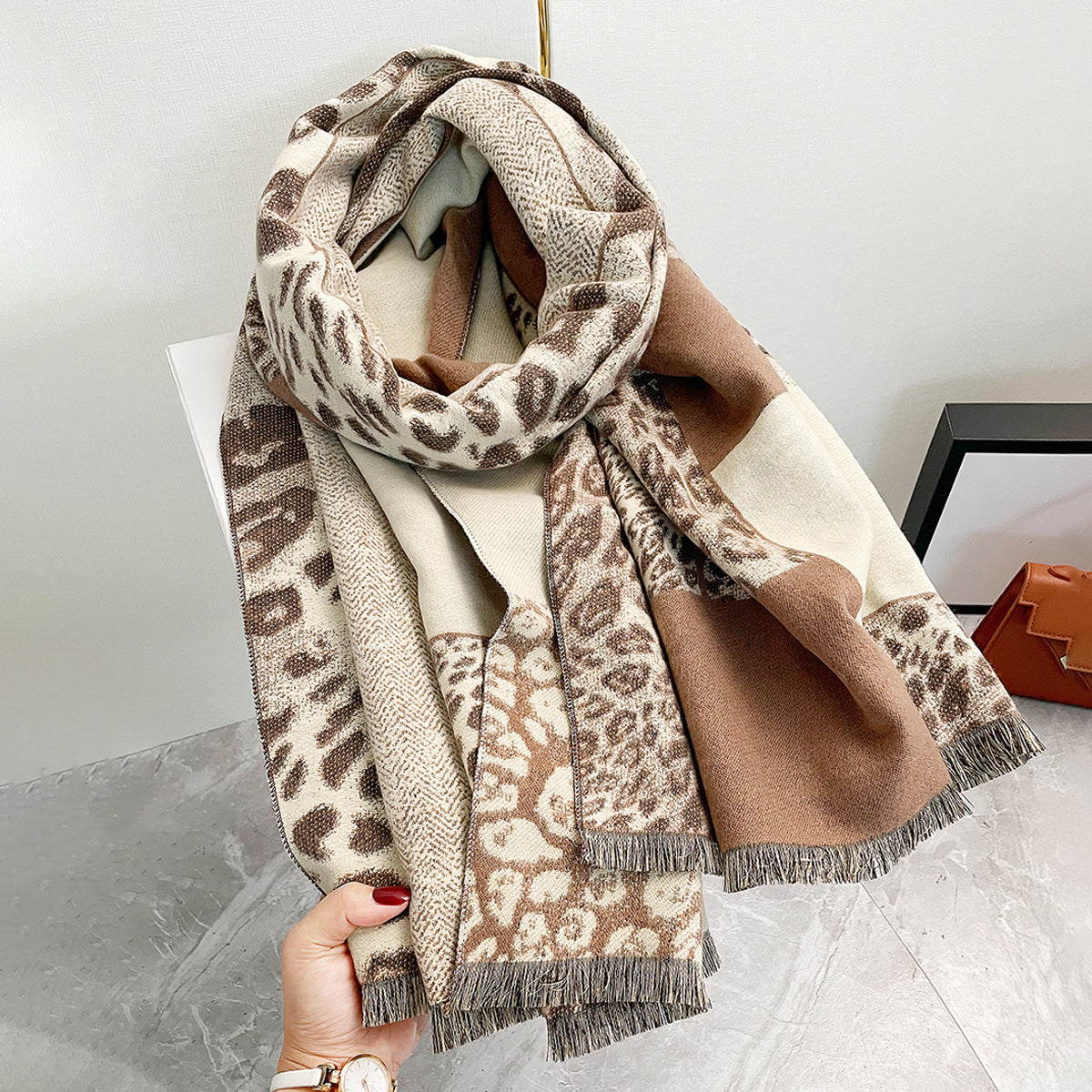 Leopard print shawl with color-block design in imitation cashmere fabric.