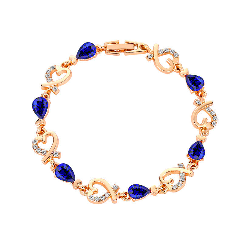 Heart-shaped bracelet with rhinestones and blue accents.