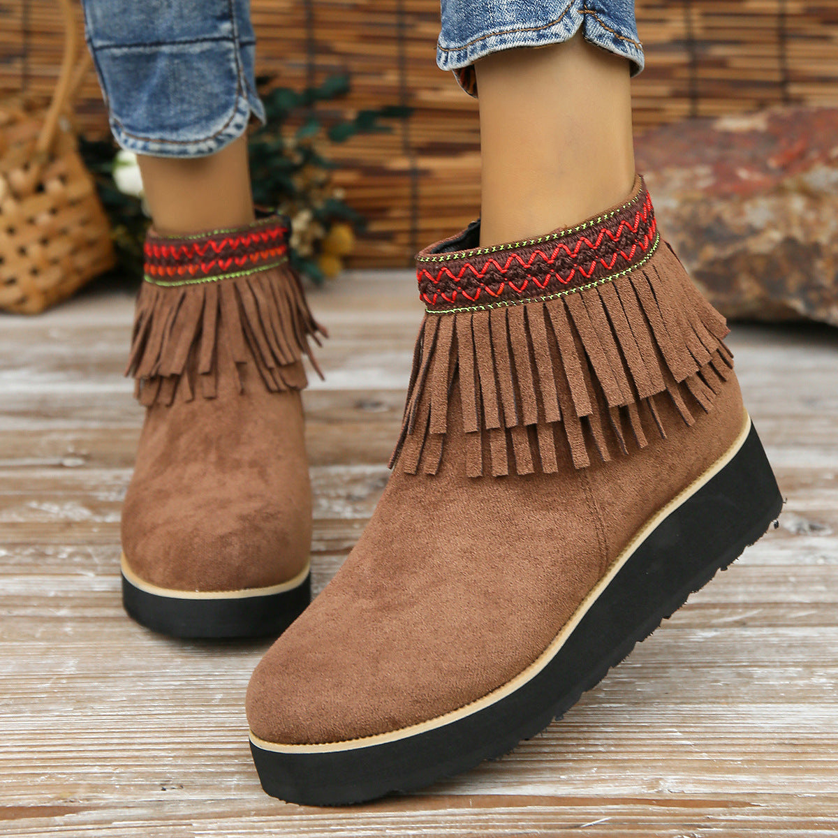 Women’s suede ankle boots with fringe, wedge heel, and rubber sole in fashion thick bottom style.