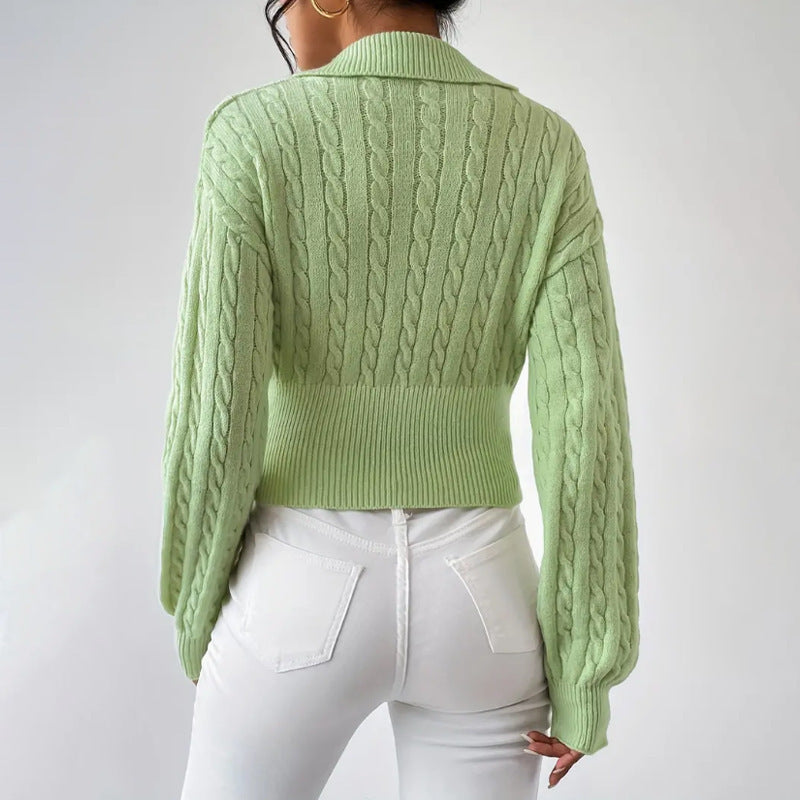 Light green V-neck cropped sweater with lapel and cuffed long sleeves.