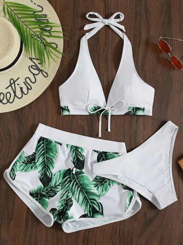 Tropical print halter neck bikini three piece set with top, bottoms, and shorts.