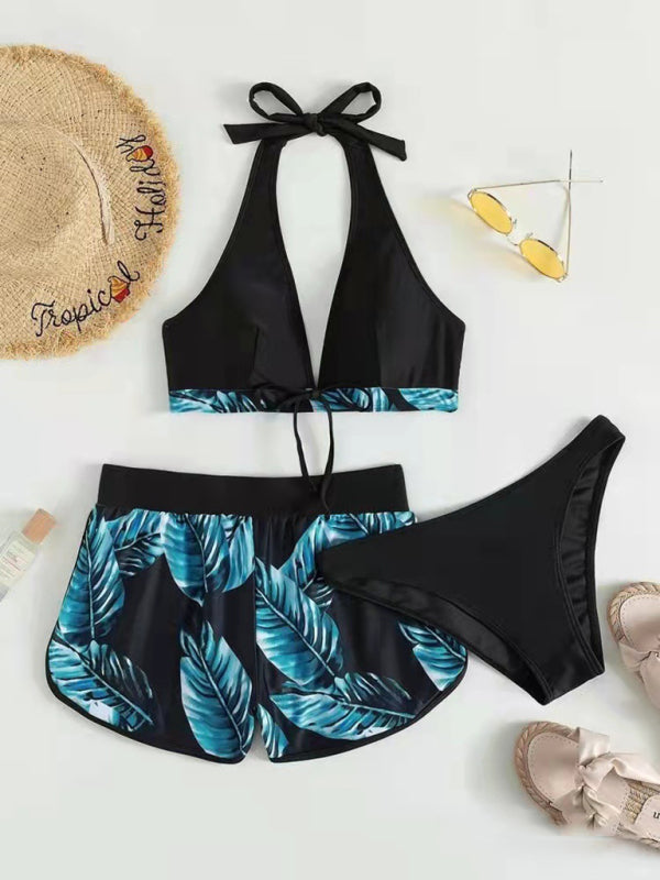 Women's three-piece tropical print halter neck bikini set with bikini top, bottoms, and swim shorts.