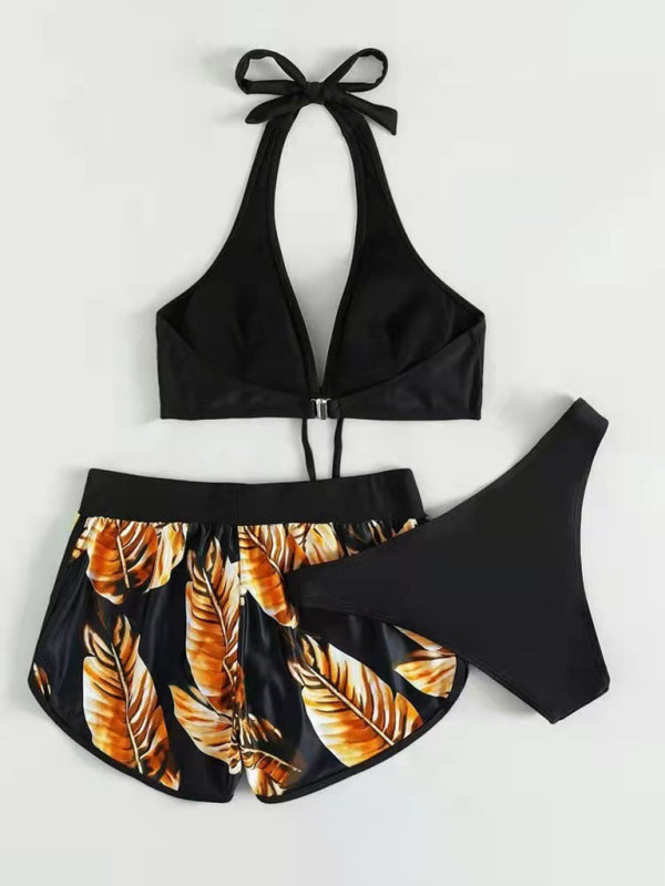 Women's tropical print halter neck bikini set with swim shorts.