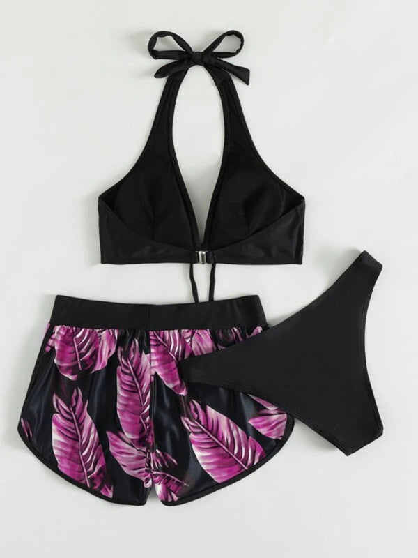 Women's tropical print halter neck bikini three-piece set with halter top, bottoms, and swim shorts.