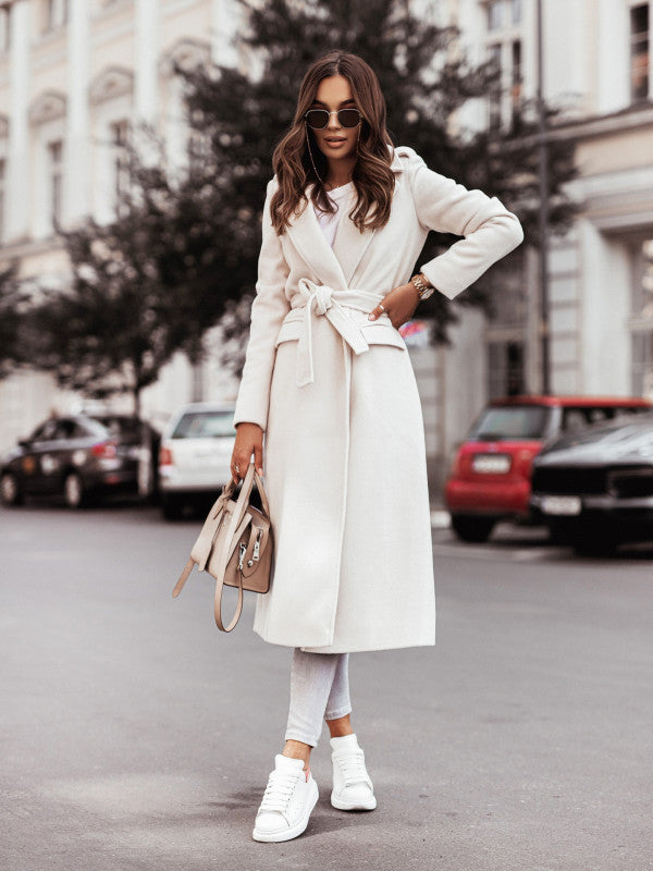 Women's long sleeve wool coat with waist tie in white, street style.