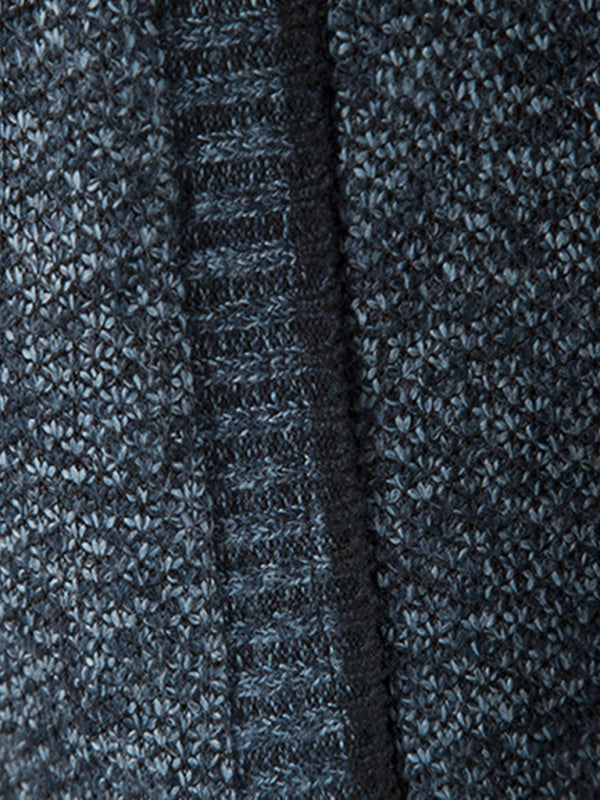 Close-up of textured fabric on men's long sleeve knit cardigan jacket in dark color.