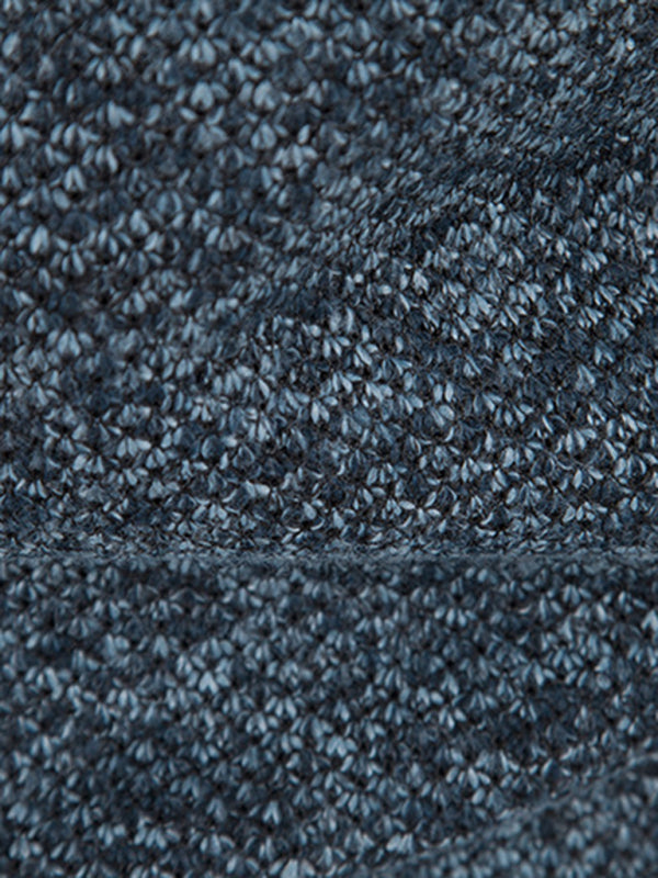 Close-up of knit fabric texture in a men's long sleeve cardigan jacket.