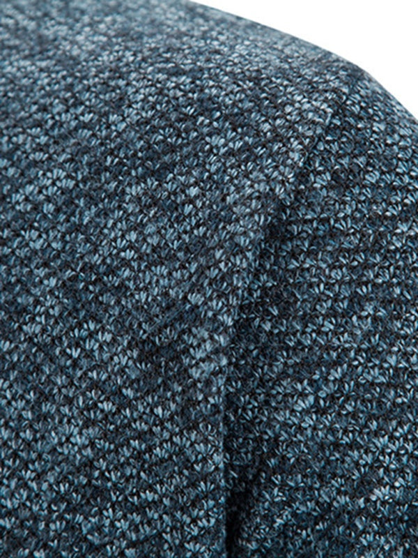Close-up of blue knit fabric texture of men's long sleeve cardigan jacket.