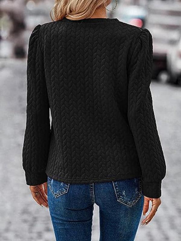 Women's black round neck patterned top with puffed long sleeves, rear view, casual autumn style.