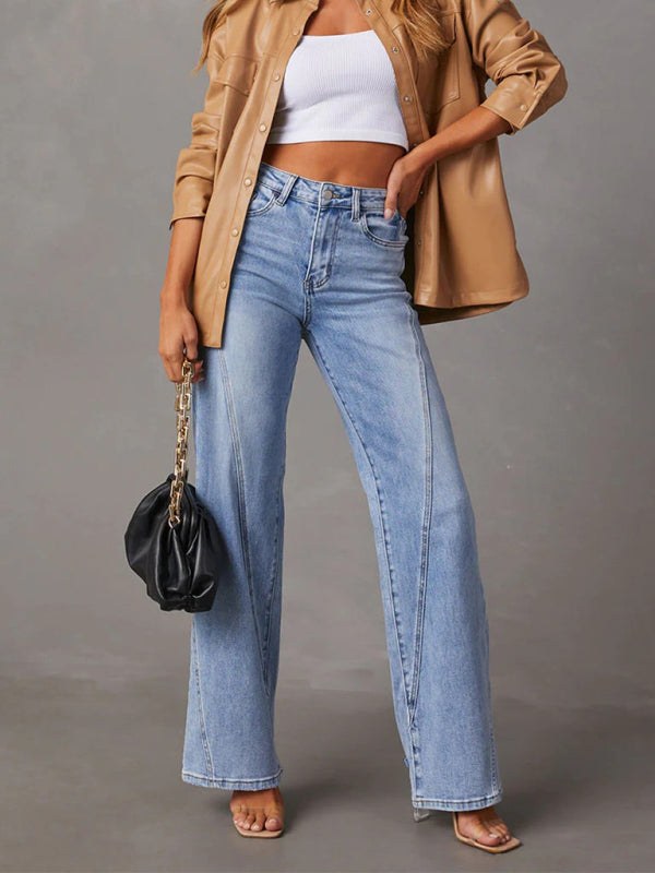 Women's wide leg high waist jeans in light blue denim, styled with a tan jacket and white top.